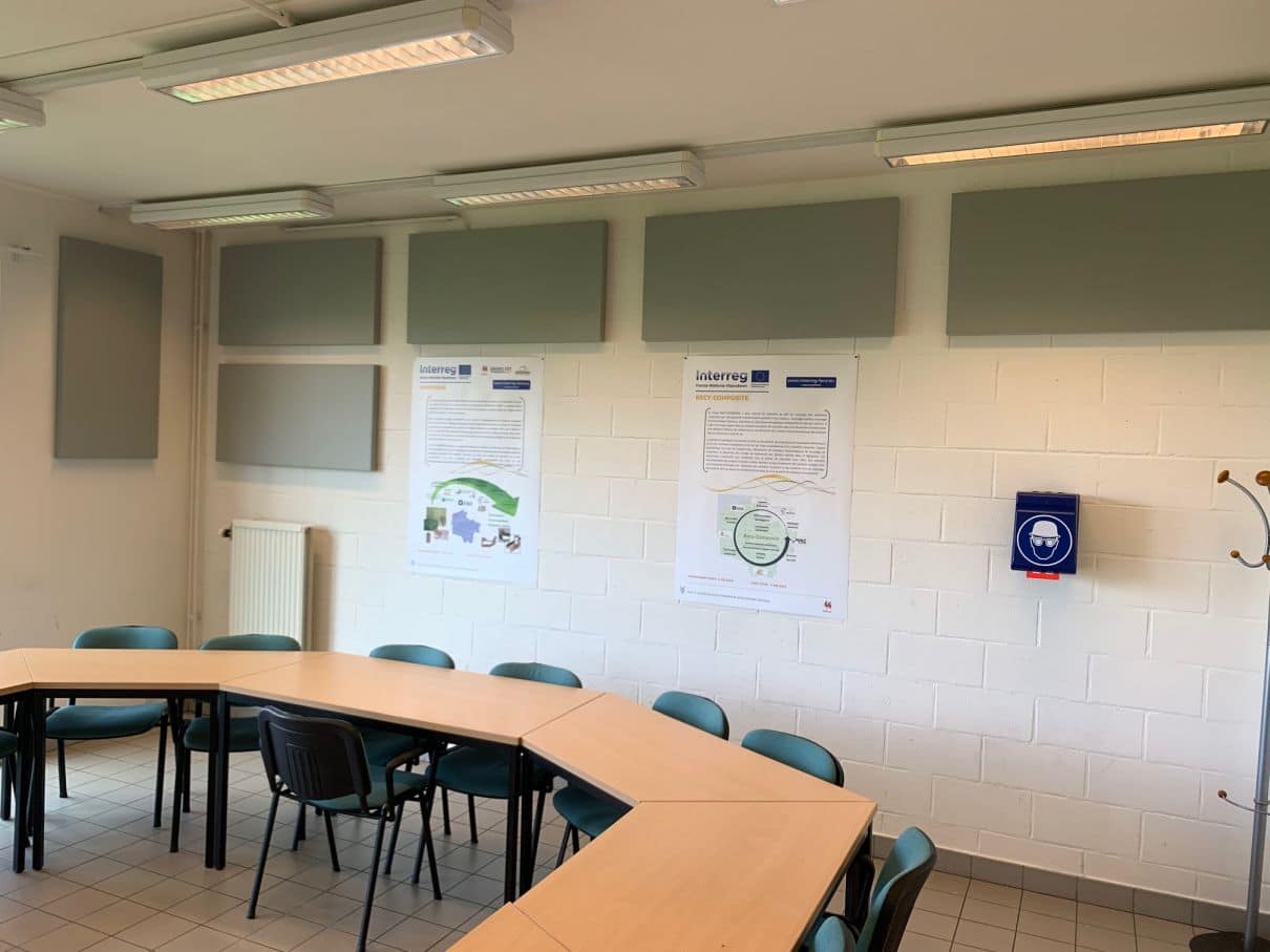 Rangée de panneaux acoustiques verts en salle de réunion aux murs blancs