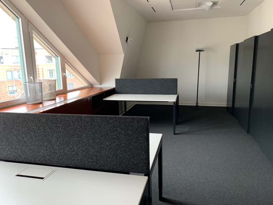 Cloisons acoustiques anthracite dans un bureau mansardé avec lucarnes