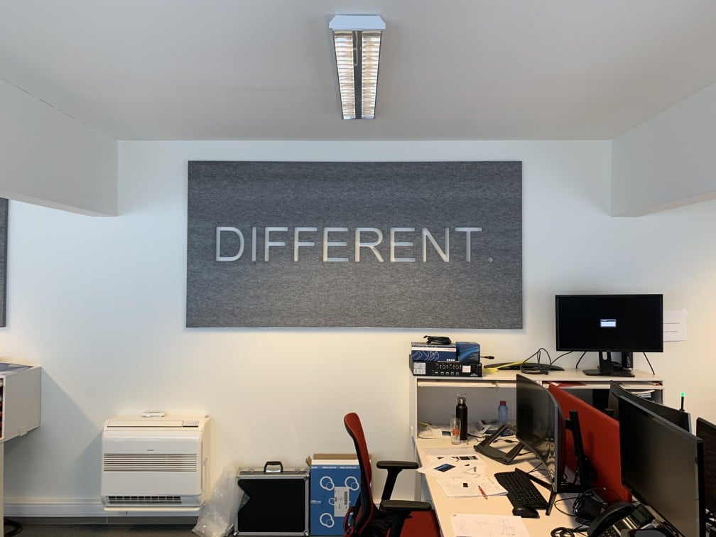 Panneau mural acoustique DIFFERENT avec lettres dans un espace de travail